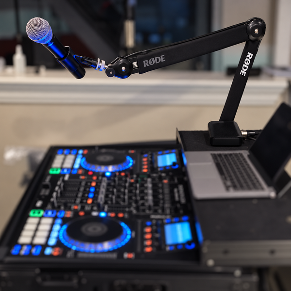 RØDE microphone boom arm in SonicSavvy’s own DJ setup, with the surrounding equipment softly blurred.